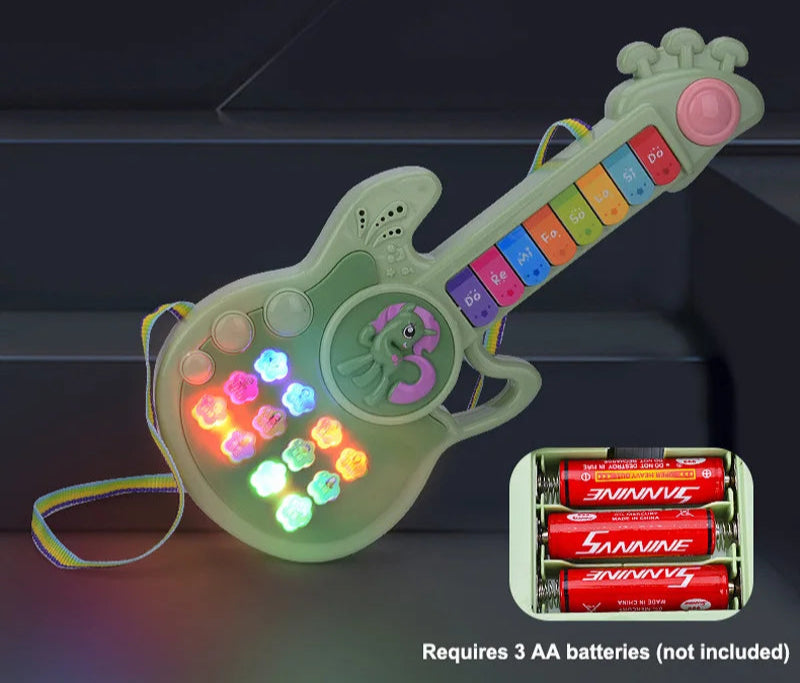 Toy guitar with LED lights and batteries on a dark background
